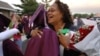 Laquetta Smith, right, gives a congratulatory hug to Lauryn Scott, after the Kalamazoo Central High School graduation ceremony Wednesday, June 7, 2006, at Wings Stadium In Kalamazoo, Mich. Kalamazoo Central was the first graduating class to qualify for th