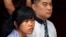 FILE - Philippine national Mary Jane Fiesta Veloso, left, who is on death row for drug offences, accompanied by an unidentified interpreter, attends her judicial review hearing at Sleman District Court in Yogyakarta, Indonesia, March 4, 2015.
