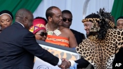 FILE - South Africa's President Cyril Ramaphosa, left, shakes hand with King Misuzulu kaZwelithini as he hands over a certificate of recognition at the Moses Mabhida Stadium in Durban, South Africa, on Oct. 29, 2022. 