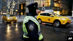 A New York City police officer stands watch outside Trump Tower, Dec. 5, 2016, in New York. 