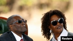 FILE - Zimbabwe's former president Robert Mugabe and his wife Grace look on after addressing a news conference at his private residence nicknamed "Blue Roof" in Harare, Zimbabwe, July 29, 2018. 