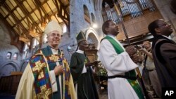 FILE: The Archbishop of Canterbury Justin Welby, left, accompanied by then-Archbishop of Kenya Eliud Wabukala, center left, leaves after conducting a service at the All Saints Cathedral in Nairobi, Kenya on Sun. Oct. 20, 2013. 