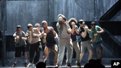 Andy Karl, center, performs with the cast of "Rocky: The Musical," during a rehearsal for the Tony Awards at Radio City Music Hall in New York, June 6, 2014. 