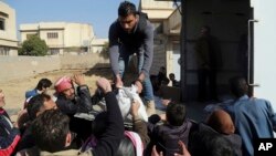 Residents of a neighborhood recently liberated from Islamic State militants gather for humanitarian aid in the eastern side of Mosul, Iraq, Jan. 11, 2017. 