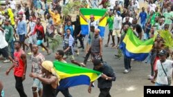 FILE - People celebrate in support of the putschists in a street of Libreville, Gabon August 30, 2023 