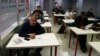 Osama Abdul Mohsen (L), a Syrian refugee, attends a Spanish lessons at a YMCA social center in Getafe, outside Madrid, Spain, April 21, 2016. 