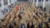 FILE - Indigenous tobacco farmers are seen at Boka Tobacco auction floors, in Harare, Zimbabwe, Tuesday May 14, 2013.