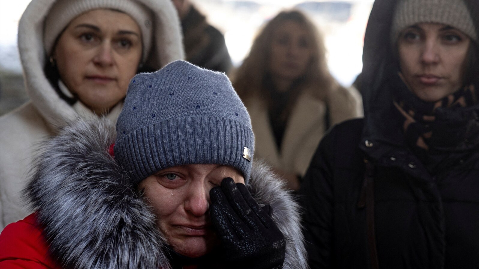 People attend a memorial event marking the 3rd anniversary of Russia's invasion of Ukraine at Romanivska Bridge that was destroyed at the beginning of the war in Irpin outside in Kyiv, Ukraine, Feb. 24, 2025. 