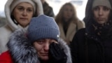 People attend a memorial event marking the 3rd anniversary of Russia's invasion of Ukraine at Romanivska Bridge that was destroyed at the beginning of the war in Irpin outside in Kyiv, Ukraine, Feb. 24, 2025. 