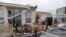 FILE - Homeowner Joe Lovece surveys the damage to the kitchen at the back of his oceanfront home after the eye of Hurricane Matthew passed Ormond Beach, Fla., Oct. 7, 2016. 