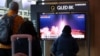 FILE - People watch a TV broadcasting a news report on North Korea firing a ballistic missile into the sea off its east coast, at a railway station in Seoul, South Korea, March 16, 2023. 