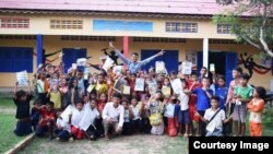 Oun Kosorl posed in a group photo in front of Mother Home Cambodia, a school he founded that provides free education to rural Cambodian students. (Courtesy of Oun Kosorl) 