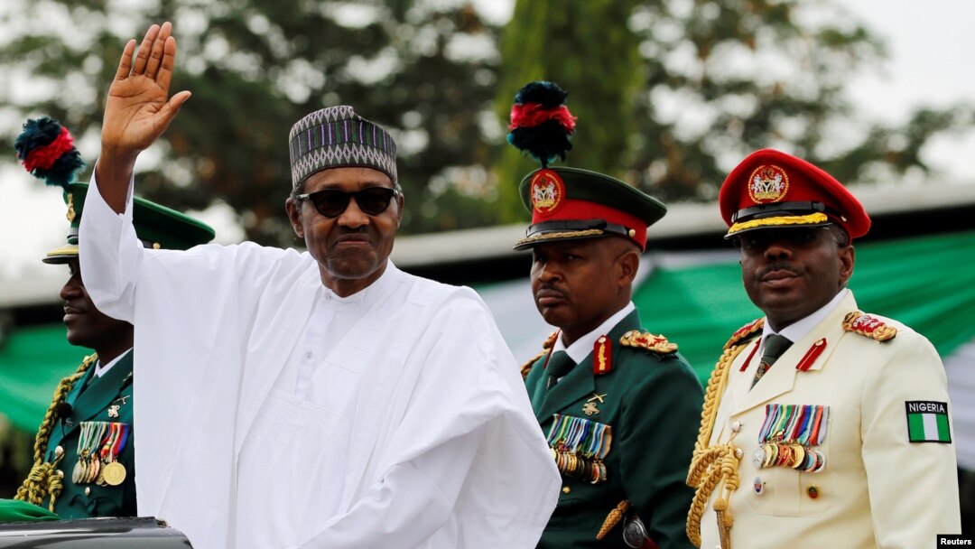 Nigerian President Muhammadu Buhari waves at the crowd while he drives around the venue during his inauguration for a second term in Abuja, Nigeria, May 29, 2019.