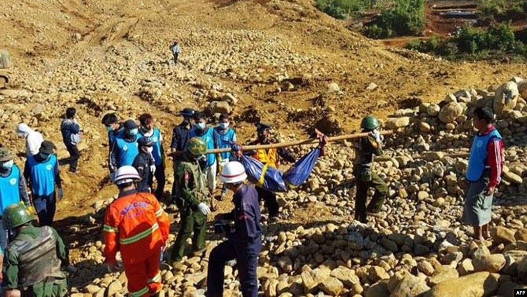 Soldiers carry the bodies of miners killed by a landslide in a jade mining area in Hpakhant, in Myanmar's Kachin state. Nov. 22, 2015. 