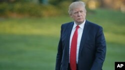 FILE - President Donald Trump walks across the South Lawn of the White House in Washington.