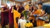 Monks bow and present “khata” to teenage Buddhist lama, Jalue Dorje, at his 18th birthday and enthronement ceremony in Isanti, Minnesota, Nov. 9, 2024. 