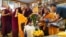 Monks bow and present “khata” to teenage Buddhist lama, Jalue Dorje, at his 18th birthday and enthronement ceremony in Isanti, Minnesota, Nov. 9, 2024. 