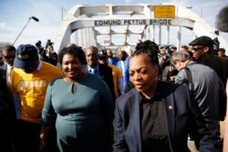 Former Georgia gubernatorial candidate and former state Rep. Stacey Abrams, second from left, walks on the Edmund Pettus Bridge in Selma, Ala., March 1, 2020, to commemorate the 55th anniversary of "Bloody Sunday."