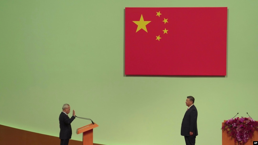 Macao's new leader, Sam Hou Fai, left, is sworn in by China's President Xi Jinping during an inauguration ceremony as part of marking the 25th anniversary of Macao's handover from Portugal to China, in Macao, Dec. 20, 2024. 