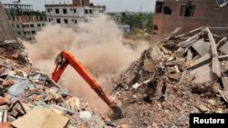 Last standing part of Rana Plaza collapses during army rescue operation in Savar, Bangladesh, May 2, 2013.