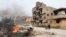 A man pulls a wheelbarrow past destroyed buildings after clashes between forces loyal to Libya's eastern government and Islamist fighters, in Benghazi, Feb. 28, 2016. Islamic State militants have expanded their control amid Libya's strife. 