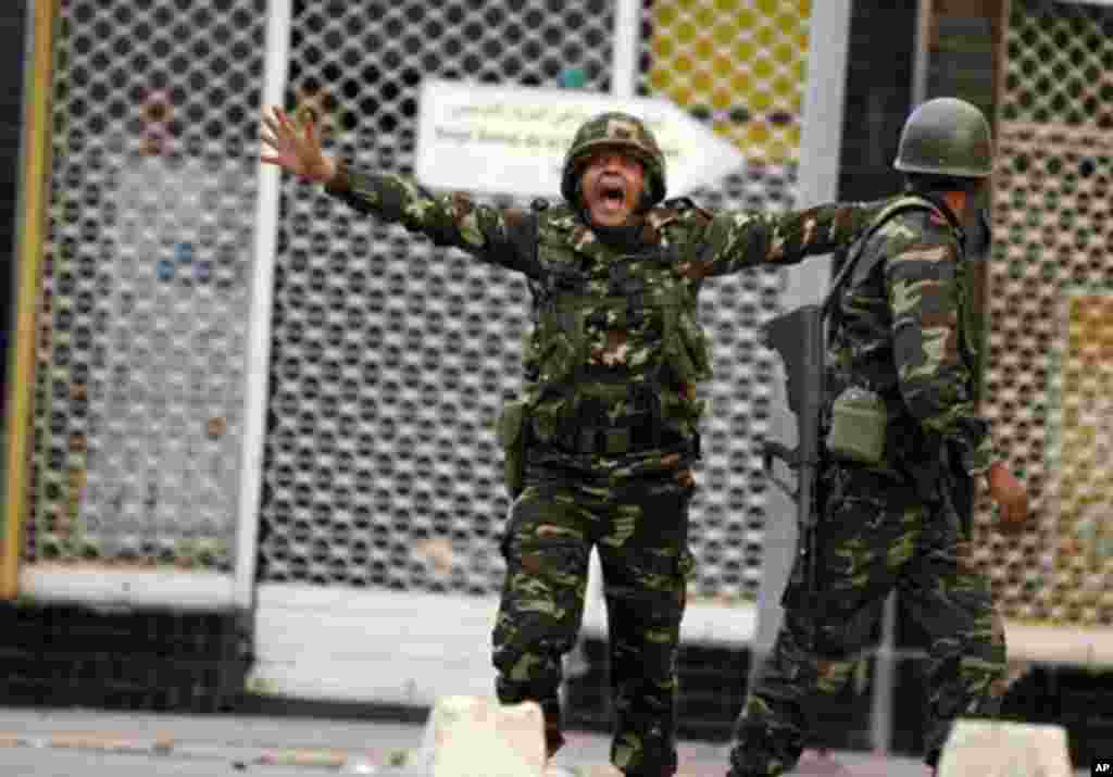A Tunisian soldier screams as he tries to calm down rioters during clashes with the police in downtown of the capital Tunis January 14, 2011. Tunisian President Zine al-Abedine Ben Ali declared a state of emergency on Friday and warned that protesters wou