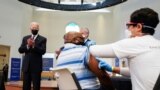 U.S. President Joe Biden applauds a man as he receives a vaccine at the coronavirus disease (COVID-19) vaccination site at Virginia Theological Seminary in Alexandria, Virginia, U.S., April 6, 2021. REUTERS/Kevin Lamarque