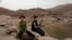 In this July 30, 2018, photo, a 17 year-old boy holds his weapon in High dam in Marib, Yemen. Experts say child soldiers are “the firewood” in the inferno of Yemen’s civil war, trained to fight, kill and die on the front lines. (AP Photo/Nariman El-Mofty)