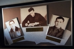 FILE - Grainy, black-and-white photos of the captain and captured crew hang in the USS Pueblo in Pyongyang, North Korea, Jan. 24, 2018.