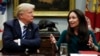 FILE - President Donald Trump, looks to Brooke Rollins, then-president and CEO of the Texas Public Policy Foundation, as she speaks during a prison reform roundtable in the Roosevelt Room of the Washington, Jan. 11, 2018. 