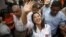Peruvian presidential candidate Keiko Fujimori greets supporters at Cerro San Cosme on the outskirts of Lima, Jan. 8, 2016. 