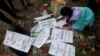 A student writes placards before a protest march demanding protection for the Amazon rainforest near the consulate of Brazil in Kolkata, India.