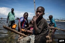 Young Mozambican fishermen return to the shore after several days of fishing in Palma, where large deposits of natural gas where found offshore, Feb. 16, 2017.