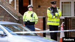 Police officers attend the scene of a shooting at Poplar Row in Dublin, Ireland, Feb. 9, 2016.