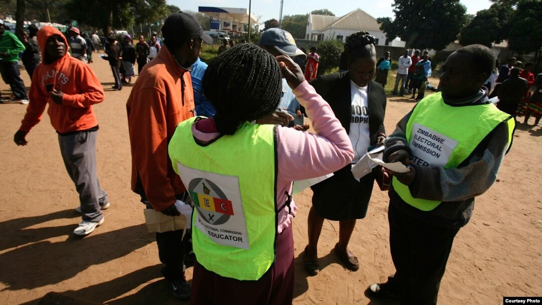 Zimbabwe Electoral Commission officials conducting an election campaign exercise outside Mai Musodzi Hall in Mbare,Harare.