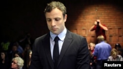 Olympic and Paralympic running star Oscar Pistorius stands during court proceedings at the Pretoria Magistrates court, August 19, 2013. 