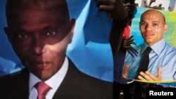 Sur cette affiche de campagne électorale de 2013, Abdoulaye Wade, au premier plan, et son fils Karim Wade, à l'arrière plan.