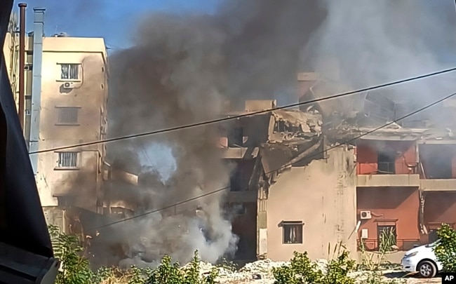 Smoke rises from a building hit by an Israeli airstrike, in the southern port city of Sidon, Lebanon, Oct. 27, 2024.