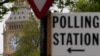 FILE - A sign points to where residents can cast their votes in London, May 3, 2024. U.K. voters are set to cast ballots in a national election on July 4, 2024.