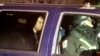 FILE - U.S.-Taliban fighter John Walker Lindh, 2nd left, rides in the back seat with security officers as they arrive at the Alexandria Detention Center in Alexandria, Virginia, Jan. 23, 2002. 