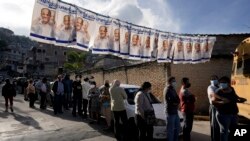 Voters line up outside a polling station during general elections in Tegucigalpa, Honduras, Nov. 28, 2021.