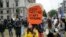 FILE - People hold placards with anti-Trump messages in central London, near the end of a protest against the state visit of President Donald Trump, June 4, 2019. 