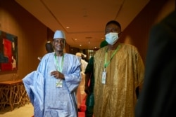 FILE - Choguel Maiga (L), a leader of the opposition coalition M5-RFP, arrives at the Sheraton hotel in Bamako on July 23, 2020, where West African leaders were to gather in a fresh push to end escalating political crisis in Mali.