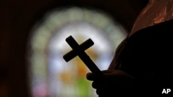 FILE - The Vatican's doctrinal office announced on Nov. 8, 2023, that transsexual people may be godparents at Roman Catholic baptisms and receive baptism themselves. (This Dec. 1, 2012, photo shows the inside of a Catholic Church in New Orleans, Louisiana.)