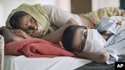 FILE - India experienced an outbreak of plague in September 1994 that killed 50 people. Above, a patient with plague symptoms, foreground, awaits test results with his mother at New Delhi’s Infectious Disease Hospital.