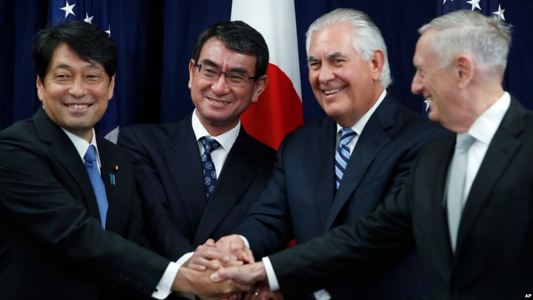 From left, Japanese Defense Minister Itsunori Onodera, Japanese Foreign Minister Taro Kono, Secretary of State Rex Tillerson and Defense Secretary James Mattis shake hands "ASEAN style" at the start of a Security Consultative Committee meeting at the State Department in Washington, Aug. 17, 2017.