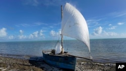 A recently arrived rustic boat sits on the shore, Jan. 4, 2023, in Islamorada, Florida.