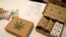 FILE - Cannabis product boxes are displayed at The Cannabis World Congress & Business Exposition (CWCBExpo) trade show in New York City, New York, May 30, 2019.
