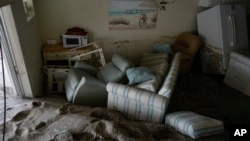 Dozens of centimeters of sand fill a condo following the passage of Hurricane Milton, at YCA Vacation Rental in Venice, Fla., Oct. 11, 2024.