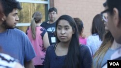 Edith Galvan, an undocumented immigrant and DACA recipient, talks to people who attended a small protest in front of the county jail in Raleigh, North Carolina. It was the first protest organized by the Meredith College student. (A. Barros, VOA)